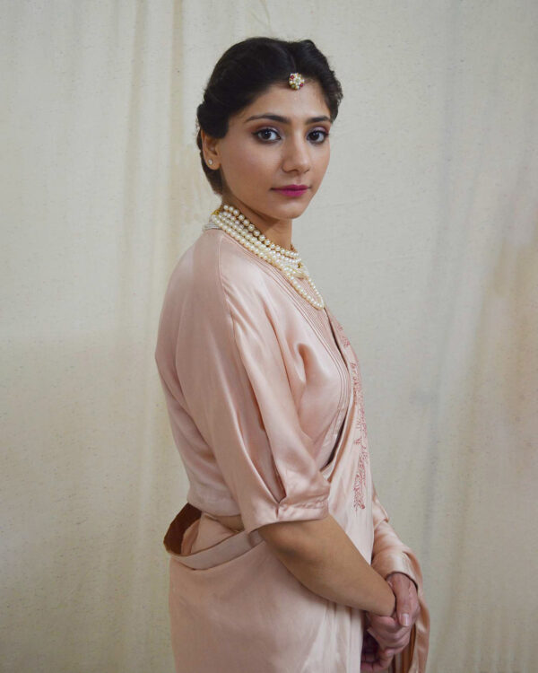 Add some romance to your wardrobe with Ahmev’s peach colored blouse